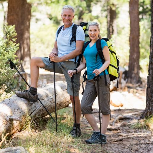 happy couple walking in the a forest