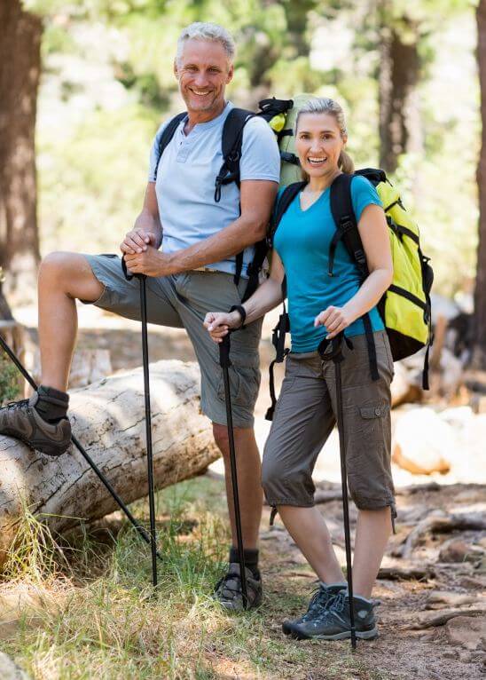 happy couple walking in the a forest